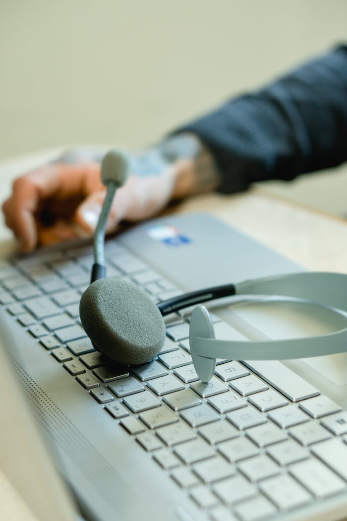 why-choose-us Close-up of a headset on a laptop keyboard, representing remote work and customer support.
