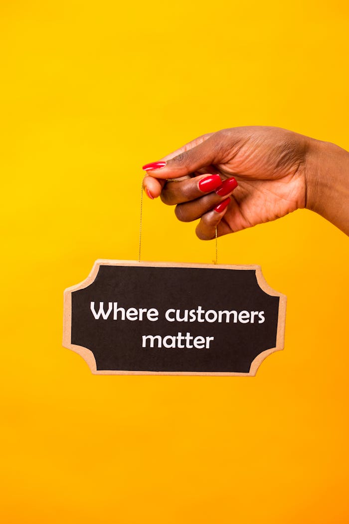 services-01 Hand holding a sign with 'Where customers matter' on a vibrant yellow backdrop.