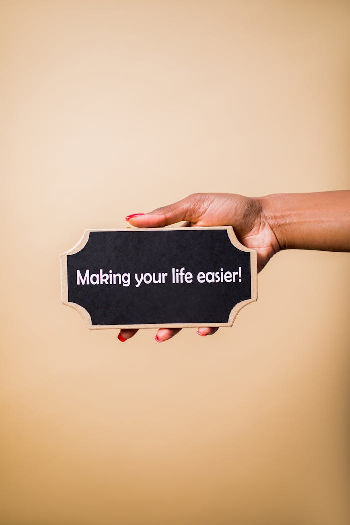 services-02 Close-up of a hand holding a sign that reads 'Making your life easier.' Perfect for motivational content.