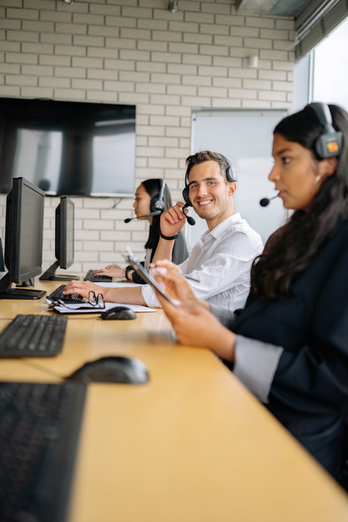 journey Three professionals at a call center collaborating in a modern office environment.