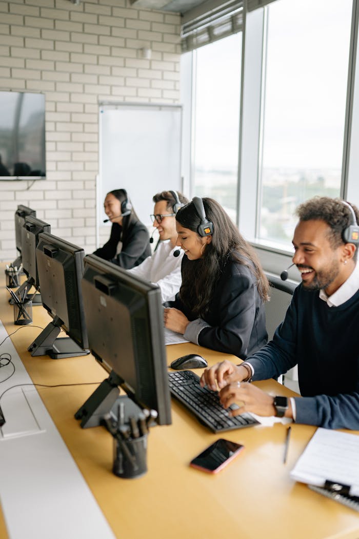 team-01 A diverse group of call center employees working together at desks in a modern office.